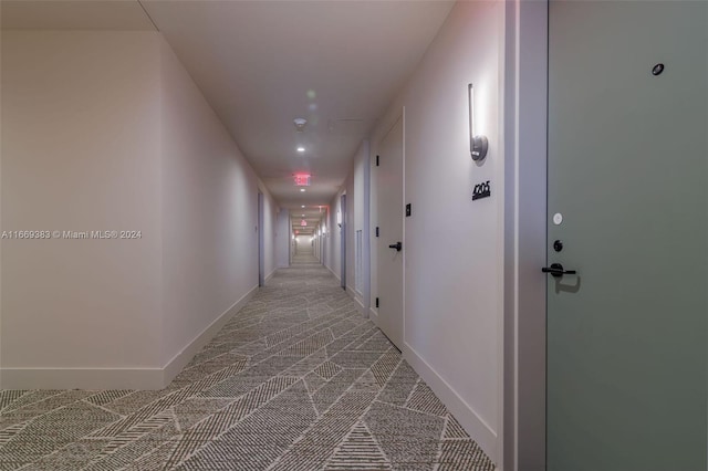 hall with light colored carpet