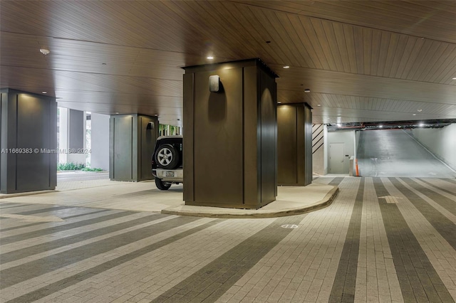 hall featuring light colored carpet and wooden ceiling