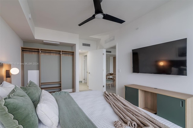 bedroom with light carpet, a closet, and ceiling fan