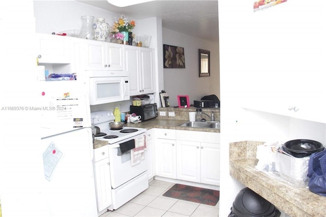 kitchen featuring light tile patterned floors, sink, white appliances, and white cabinetry