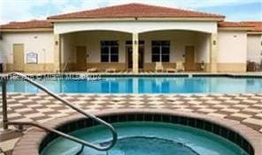 view of pool featuring a community hot tub