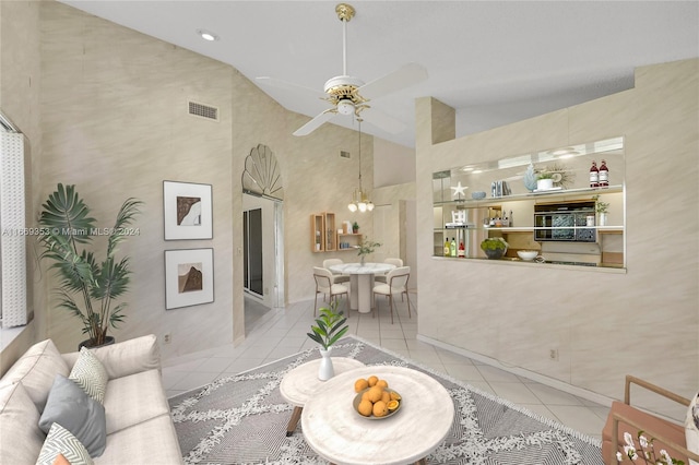 living room featuring high vaulted ceiling, ceiling fan, and light tile patterned floors