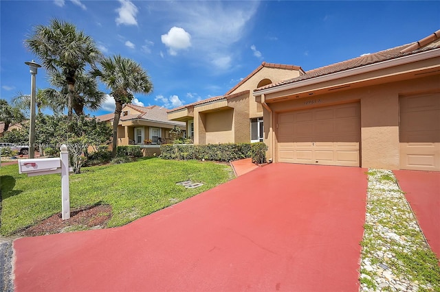 view of front of home featuring a garage and a front lawn