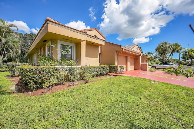 view of front of home with a garage and a front lawn