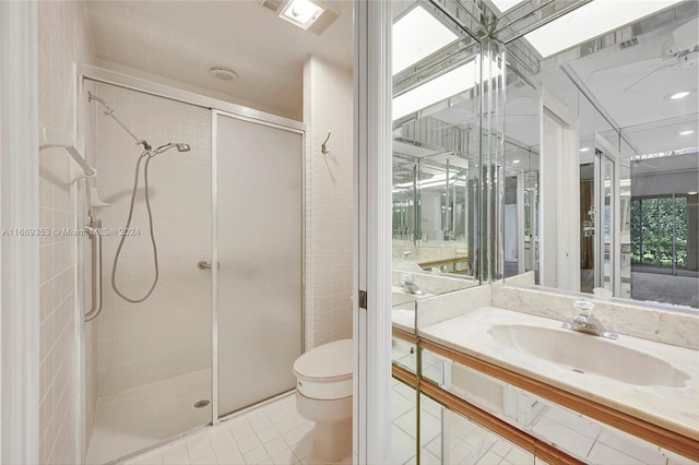 bathroom with vanity, toilet, tile patterned floors, and a shower with shower door