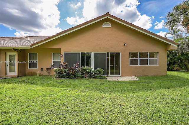 back of house featuring a yard