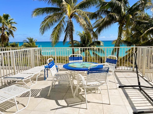 view of patio / terrace with a hot tub and a water view