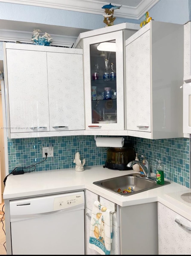 kitchen featuring decorative backsplash, white cabinetry, dishwasher, and sink