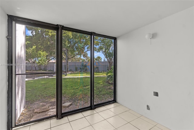 interior space with light tile patterned flooring and expansive windows