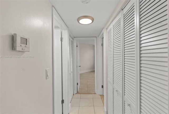 hall with light tile patterned flooring