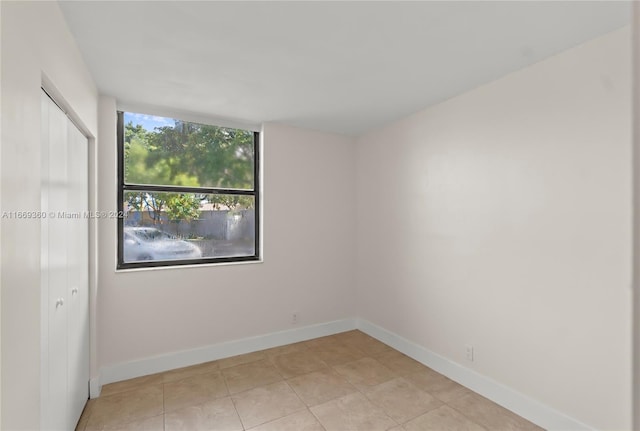 unfurnished room with light tile patterned floors