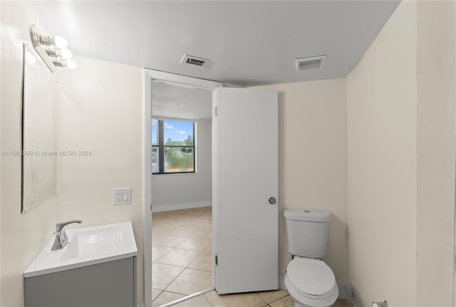 bathroom featuring tile patterned flooring, vanity, and toilet