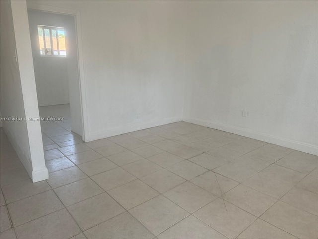 spare room featuring light tile patterned floors