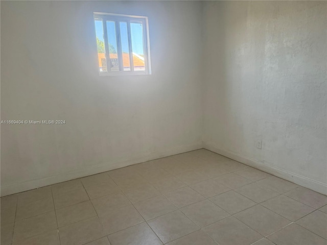 spare room with light tile patterned floors