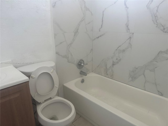 full bathroom with tiled shower / bath, vanity, and toilet