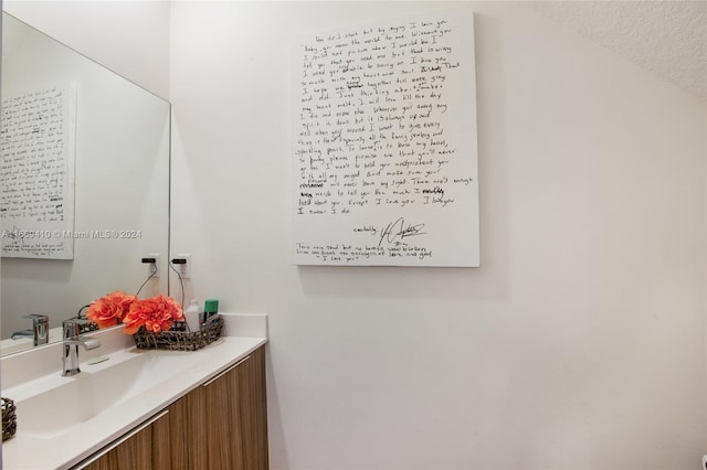 bathroom with vanity and a textured ceiling