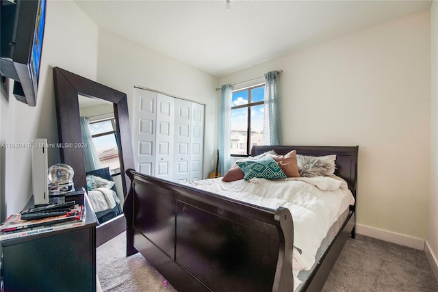 bedroom featuring a closet and light colored carpet