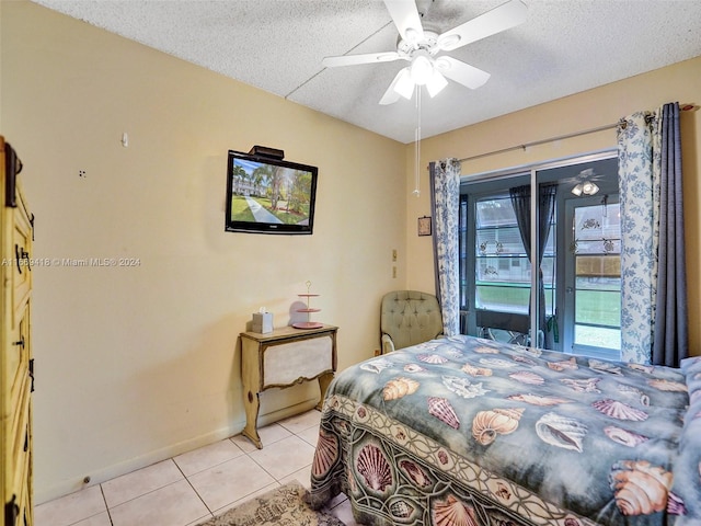 bedroom featuring a textured ceiling, light tile patterned flooring, ceiling fan, and access to exterior