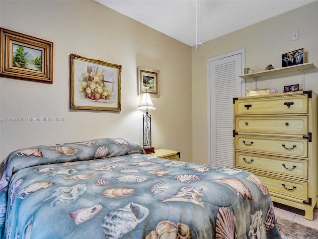 tiled bedroom featuring a closet