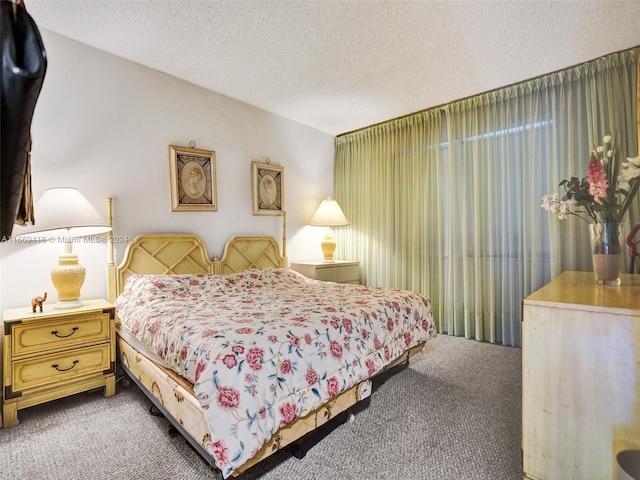 bedroom with a textured ceiling and carpet