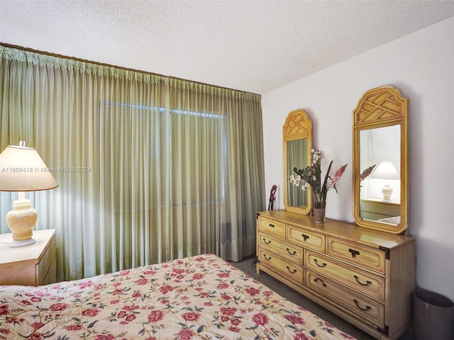 carpeted bedroom with a textured ceiling