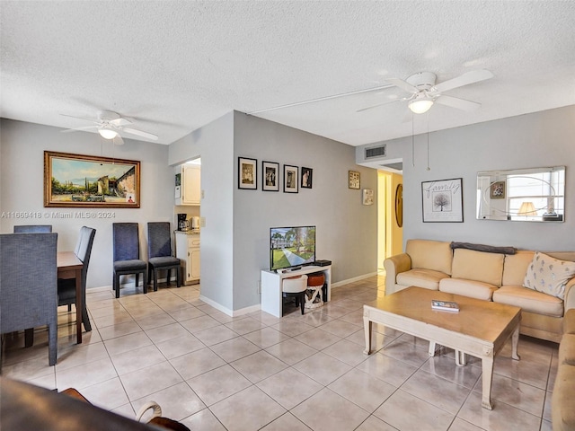 tiled living room featuring a textured ceiling and ceiling fan