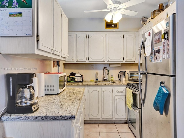 kitchen with ceiling fan, white cabinets, appliances with stainless steel finishes, and sink