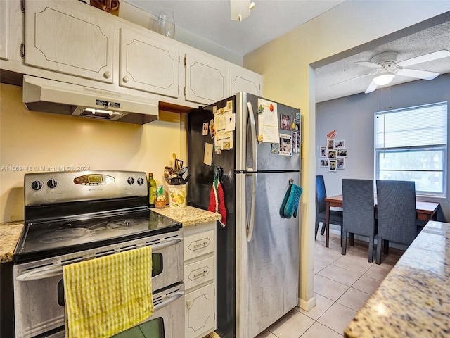 kitchen with ceiling fan, white cabinets, light tile patterned flooring, a textured ceiling, and appliances with stainless steel finishes