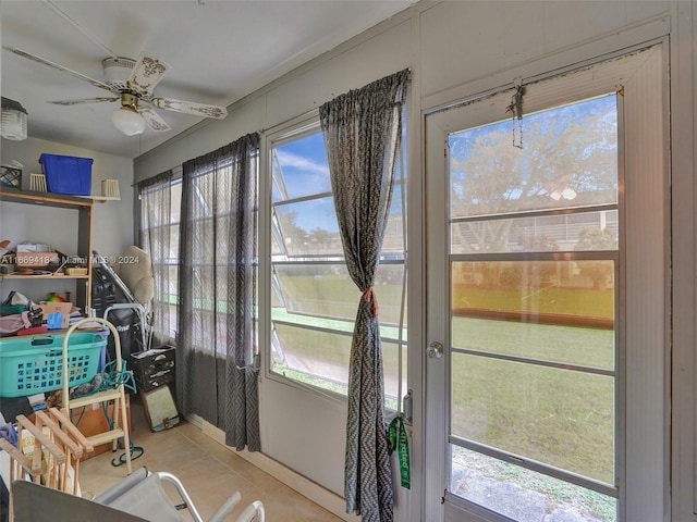 sunroom / solarium featuring ceiling fan