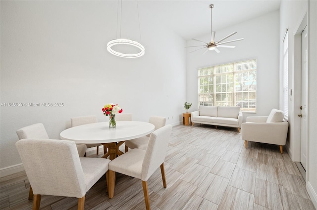 622 SW 147th Ter, Pembroke Pines, FL 33027 - dining room with baseboards, a ceiling fan, high vaulted ceiling, and light wood-style flooring