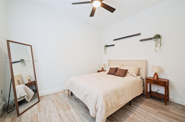 bedroom with ceiling fan and light hardwood / wood-style flooring