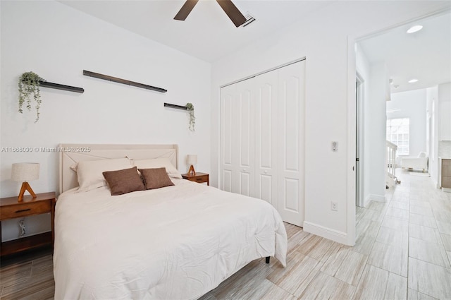 bedroom with ceiling fan, a closet, and light hardwood / wood-style floors