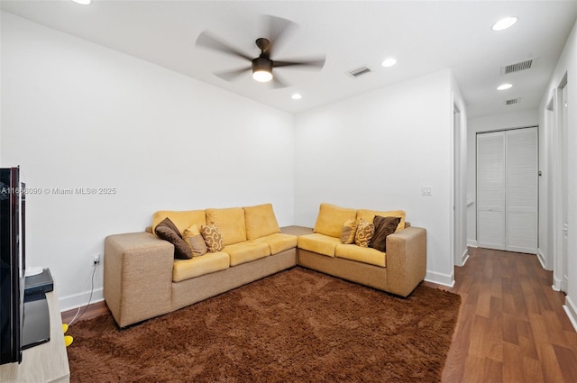 living room featuring hardwood / wood-style floors and ceiling fan