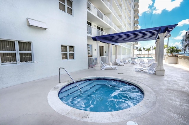 view of swimming pool featuring a pergola, a patio, and a hot tub