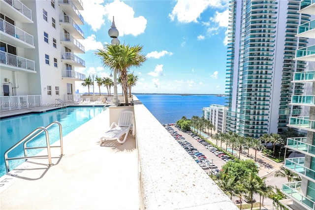 view of swimming pool with a water view