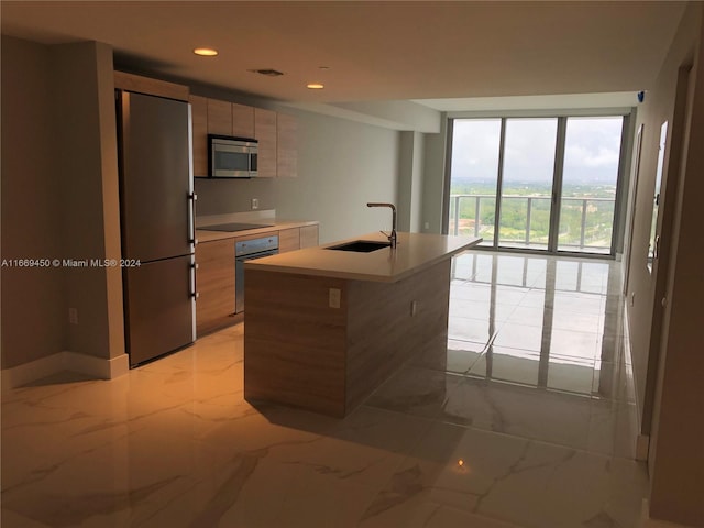 kitchen featuring a center island with sink, stainless steel appliances, and sink