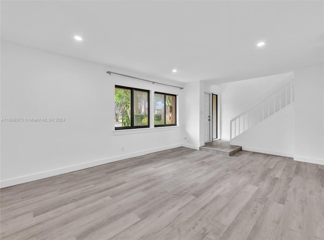 unfurnished living room with light wood-type flooring