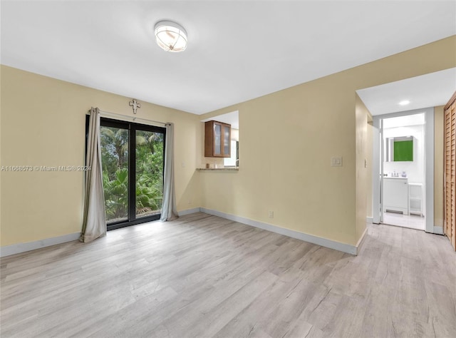 empty room with light hardwood / wood-style flooring