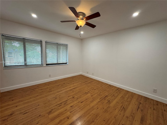 spare room with ceiling fan and wood-type flooring