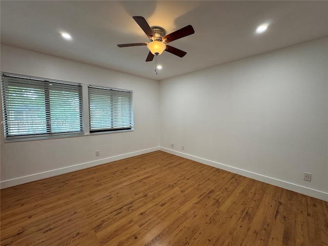 empty room with hardwood / wood-style flooring and ceiling fan