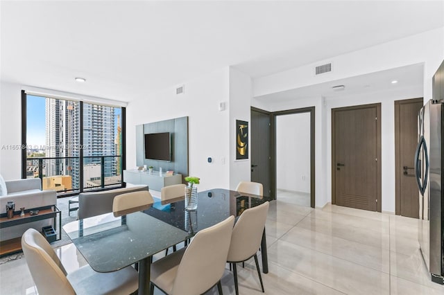 tiled dining room with floor to ceiling windows