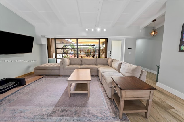 living room with light wood-type flooring and beamed ceiling