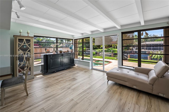 sunroom / solarium with a wealth of natural light and vaulted ceiling with beams