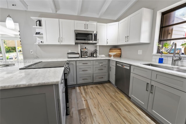 kitchen with gray cabinetry, white cabinets, appliances with stainless steel finishes, and plenty of natural light