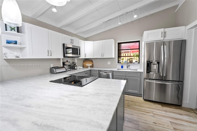 kitchen with vaulted ceiling with beams, gray cabinetry, white cabinetry, appliances with stainless steel finishes, and light wood-type flooring