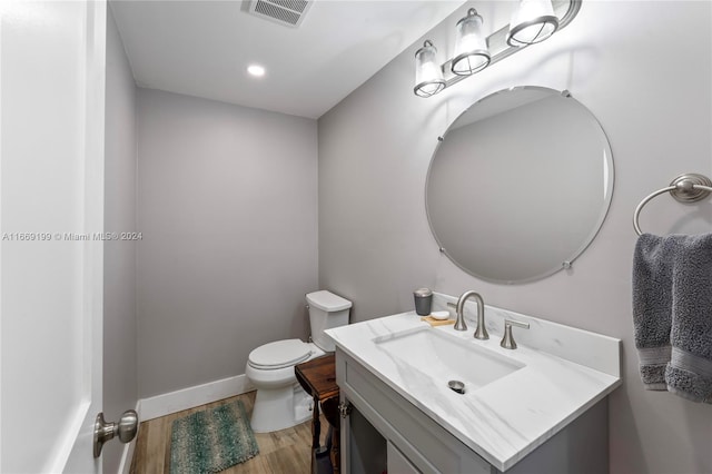 bathroom with vanity, hardwood / wood-style floors, and toilet