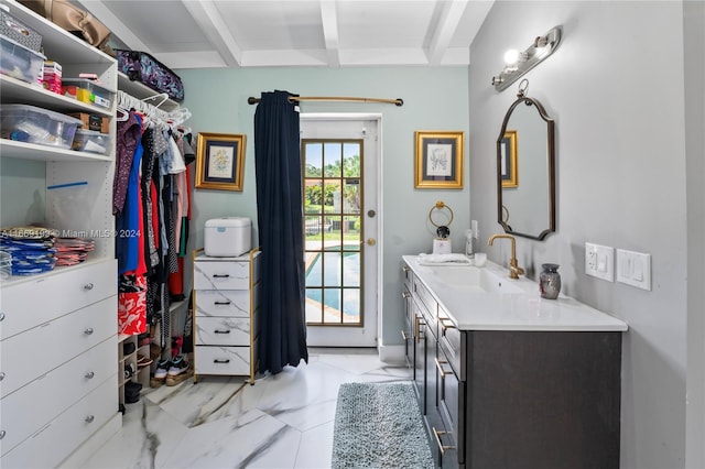 bathroom featuring vanity and beamed ceiling