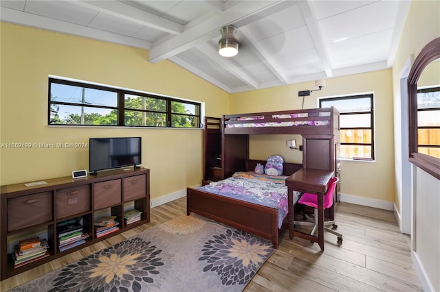 bedroom featuring light hardwood / wood-style flooring, vaulted ceiling with beams, multiple windows, and ceiling fan