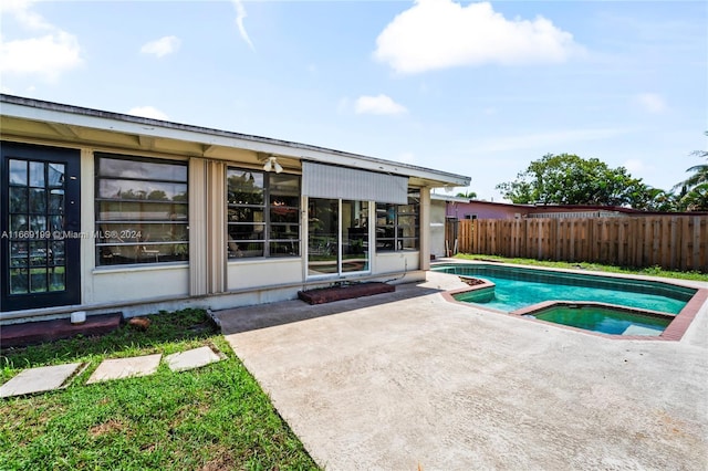 view of pool featuring a patio and an in ground hot tub