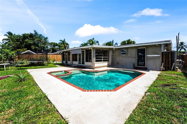 view of pool with a sunroom and a patio